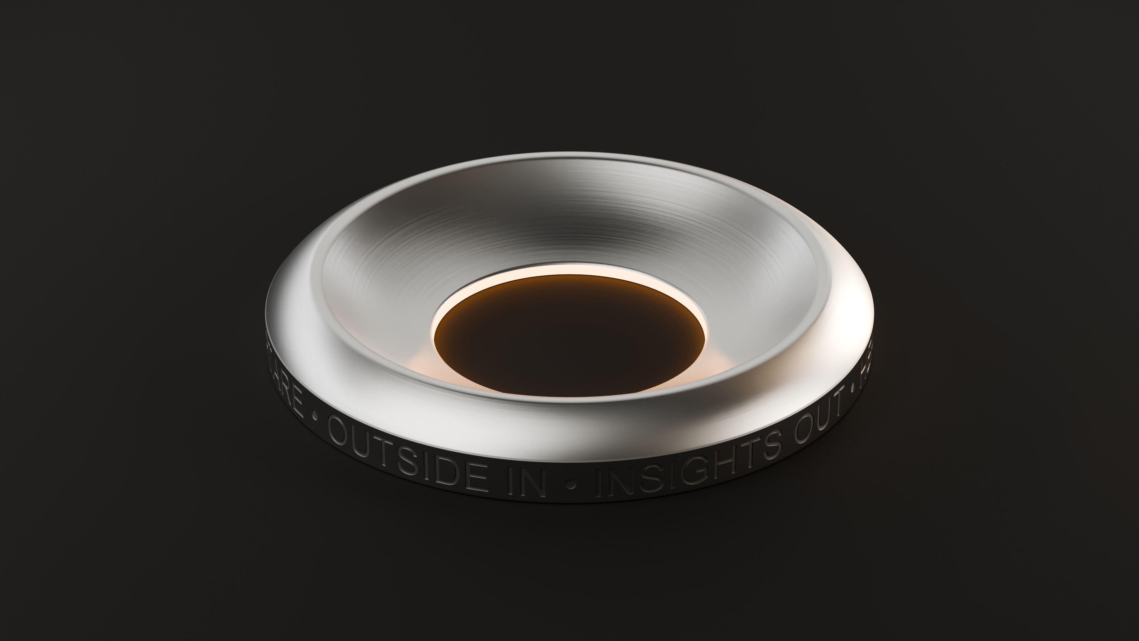 The device from above, glowing amber at the centre
